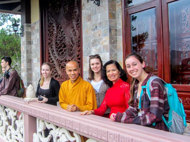 Students with monk at monestary