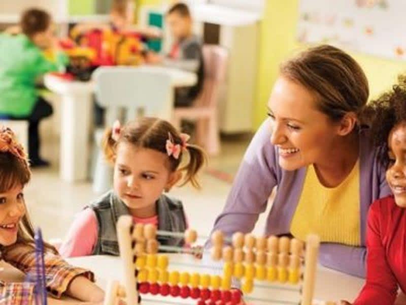 teacher playing with her students