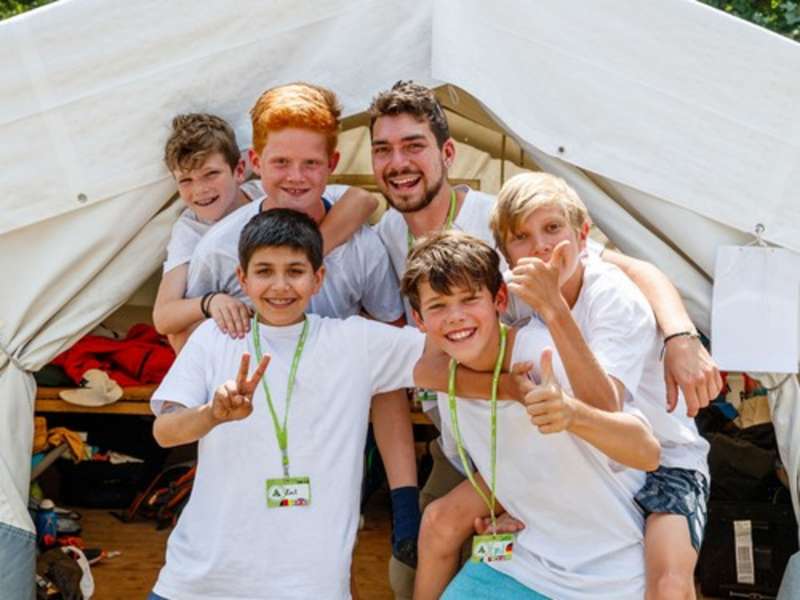 TEFL teacher leading an English summer camp in Germany with students during an outdoor learning activity.