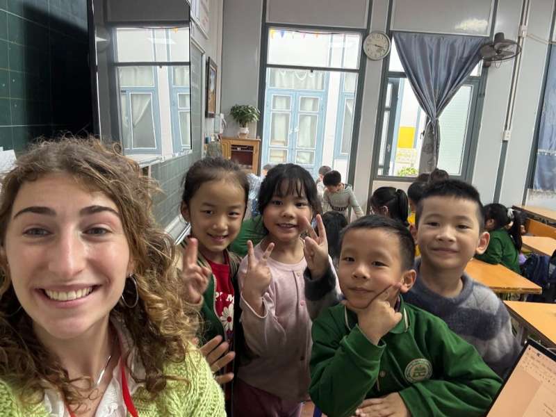 TEFL teacher with young students in a classroom in Vietnam during an English lesson.