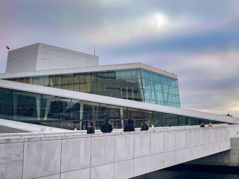 the Oslo Opera house with pink and purple sunset clouds in the sky