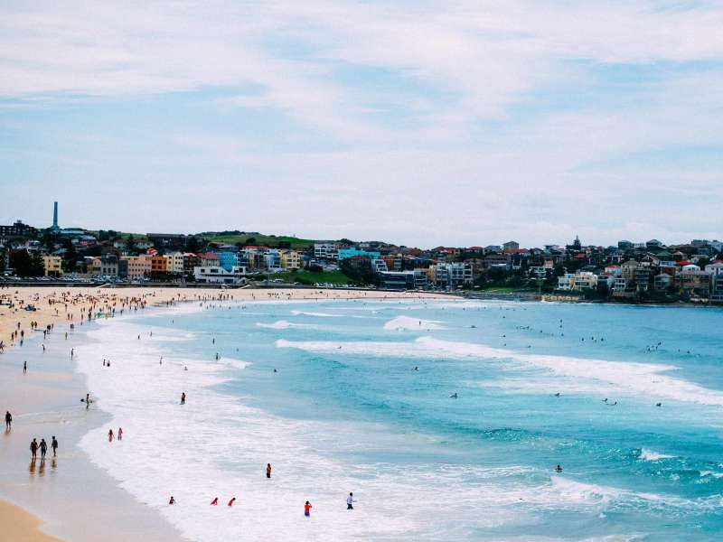 the sprawling blue Bondi Beach with many people visiting
