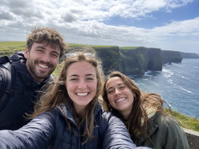 Three friends taking a selfie at the Cliffs of Moher