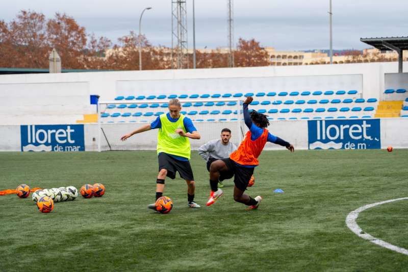 three people playing soccer