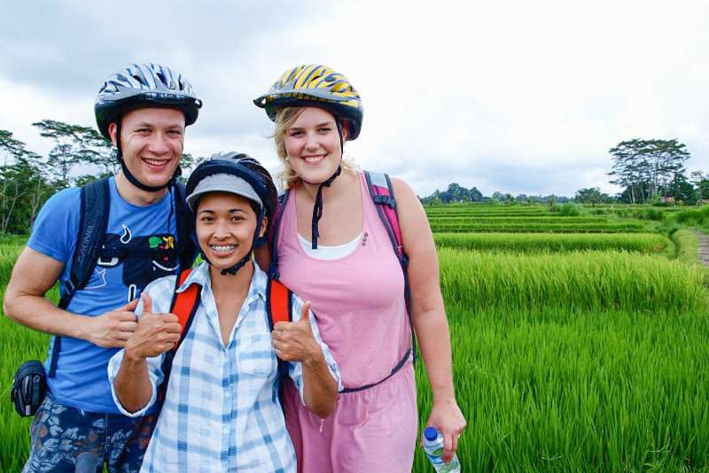 three people smile for a photo