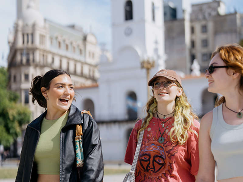 Three students walking and talking
