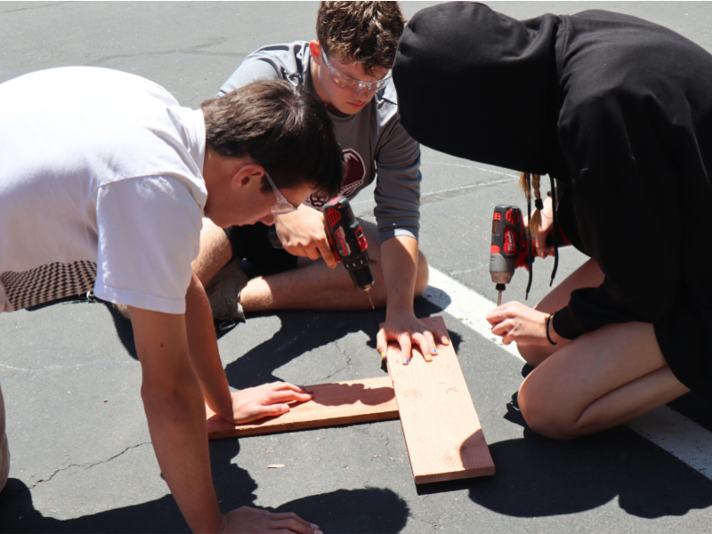 three students working together, drilling