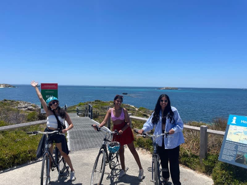 Three woman with bikes by the ocean
