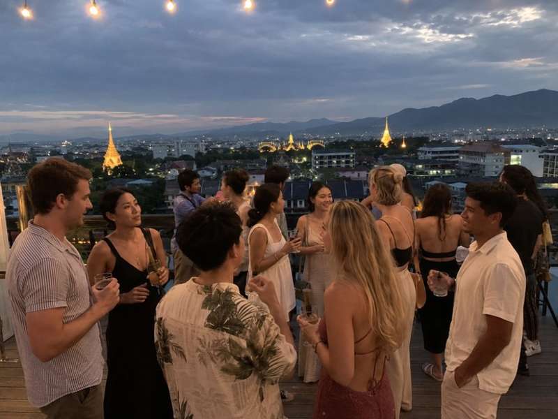 Travellers enjoying rooftop drinks above Chiang Mai