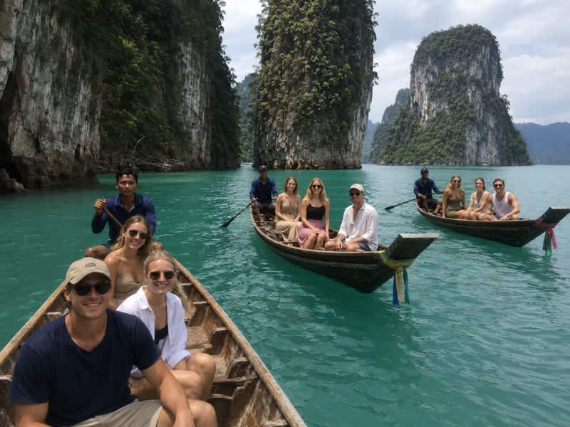 Travellers exploring limestone islands by longtail boat
