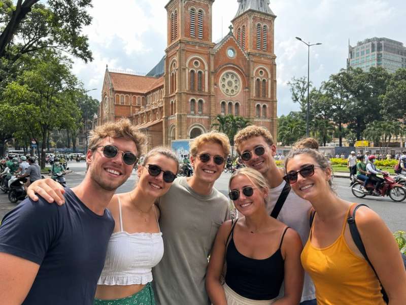 Travellers outside Notre Dame Cathedral in Ho Chi Minh City