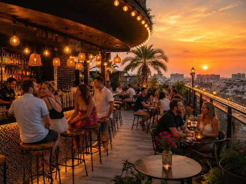 Travellers socialising at a Hanoi rooftop bar during sunset