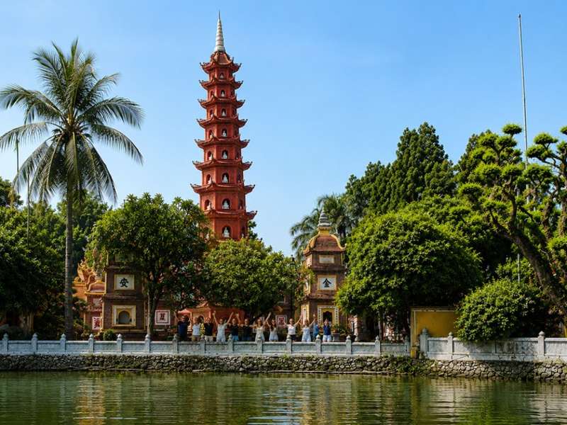 Travellers visiting Tran Quoc Pagoda beside West Lake in Hanoi