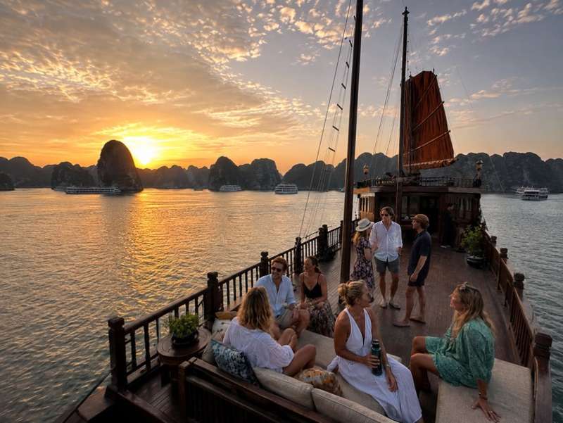 Travellers watching sunset aboard a Ha Long Bay cruise