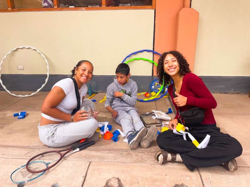Two Female Volunteers Assisting a Child in Guatemala