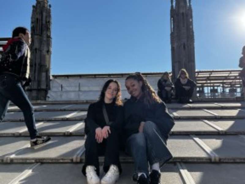 Two friends sitting on the roof of the Milan Duomo