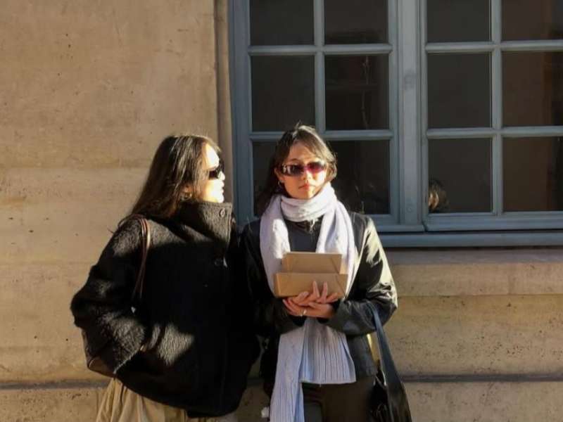 Two students hang out in between classes in Paris, France.