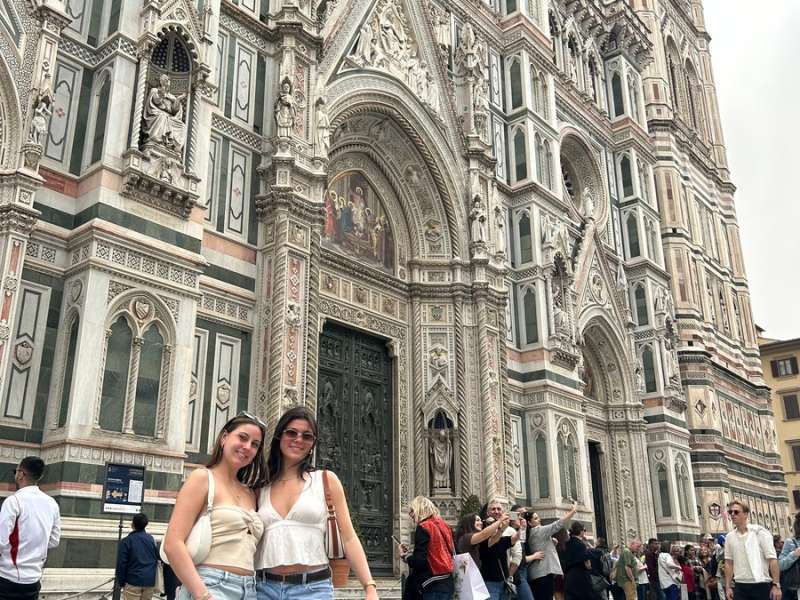 Two students posing in front of Duomo Cathedral in Florence