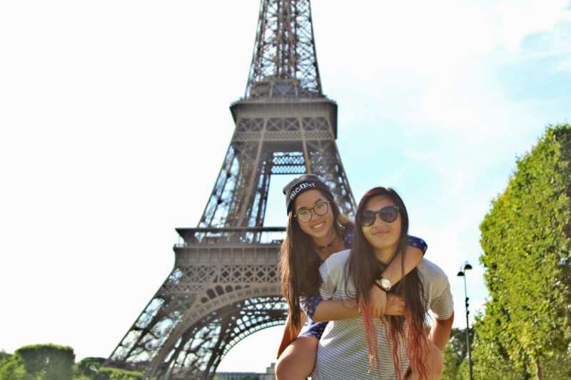 two students posing in front of eiffel tower