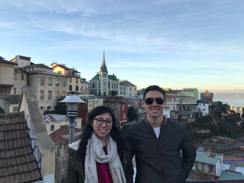 Two students smiling and chatting while teaching English together in Chile, forming a new friendship.