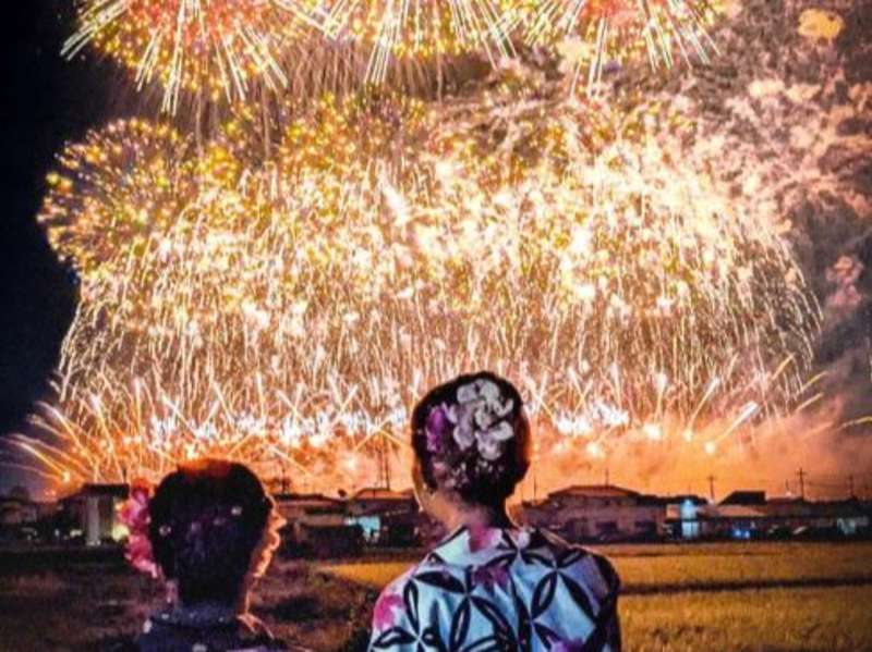Two students staring at fireworks in traditional clothing in Tokyo, Japan.