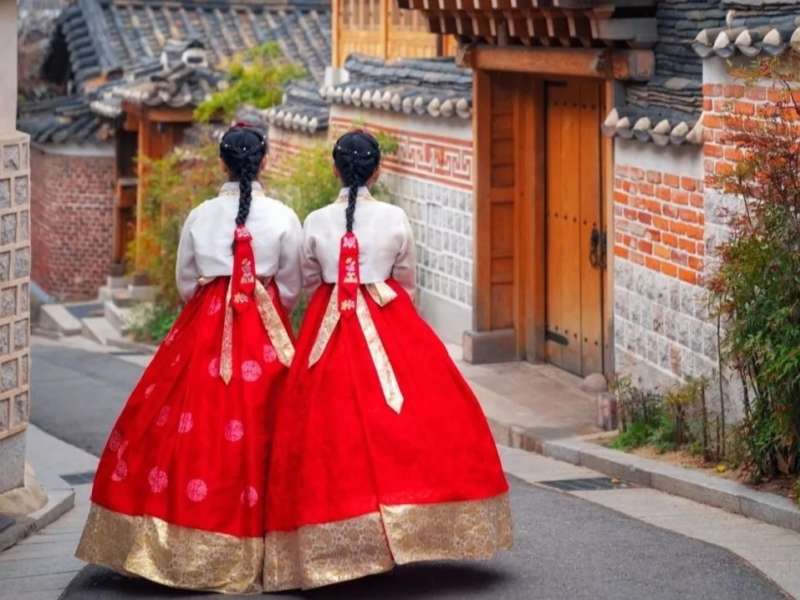 Two women walking in traditional dress in South Korea