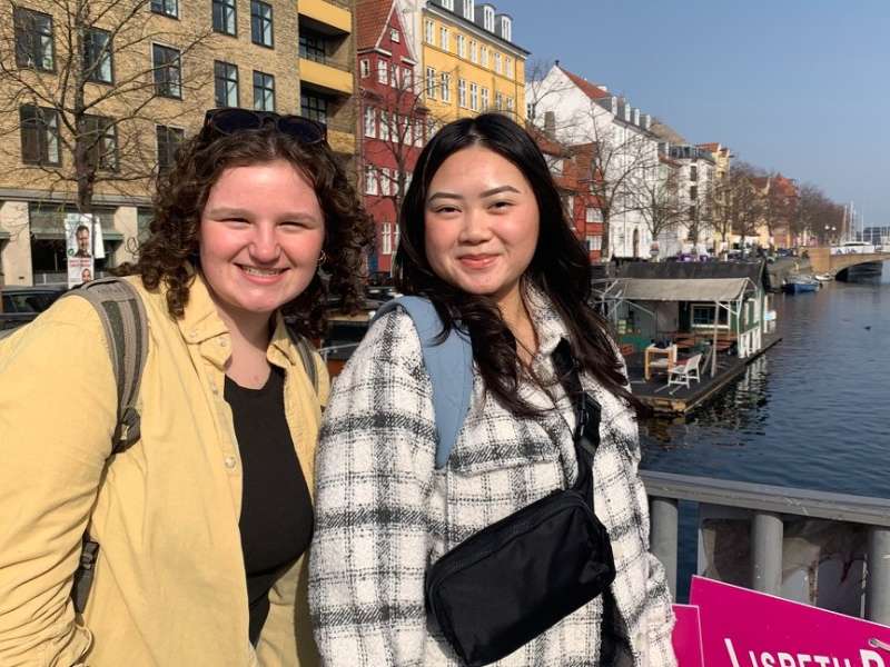 two young college students pose on a bridge in Copenhagen