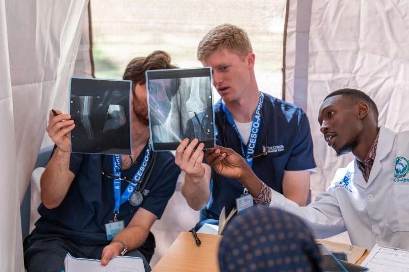 UCESCO medical volunteers and local healthcare professional looking at x-ray images