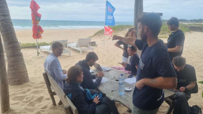 volunteer group working, beach background