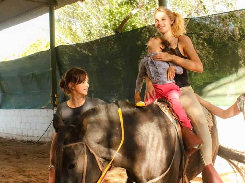 volunteer helping in the rehabilitation of a child