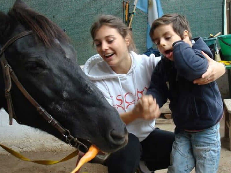 volunteer helping in the rehabilitation of a child
