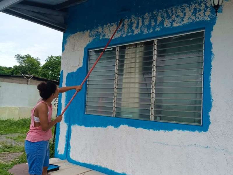 Volunteer painting a building in Panama