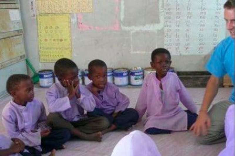 volunteer teaching young boys in Zanzibar