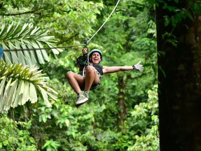 Volunteer zip lining through the jungles of Costa Rica