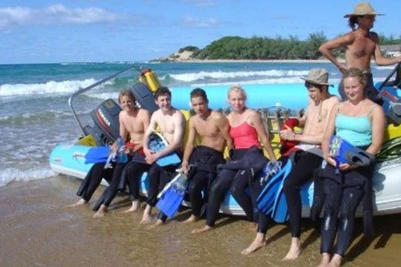 Volunteers by the boat