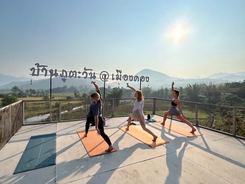 Volunteers in Thailand doing yoga on yoga deck in the jungle