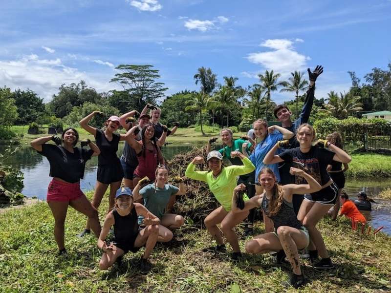 Volunteers posing in Hawaii after working on local project on farm