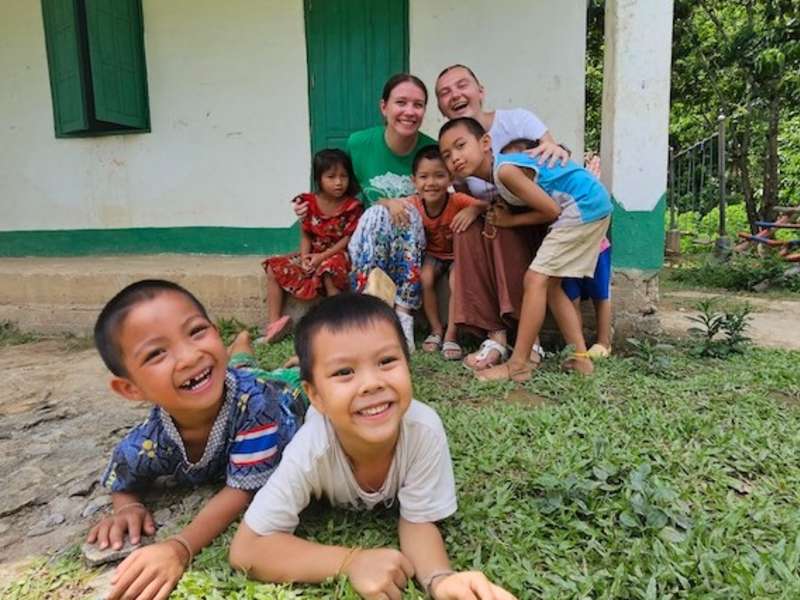 Volunteers with local children in Laos during an English lesson