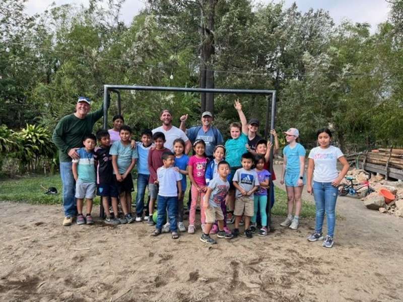 Volunteers with Local Children Showing their Finished Project