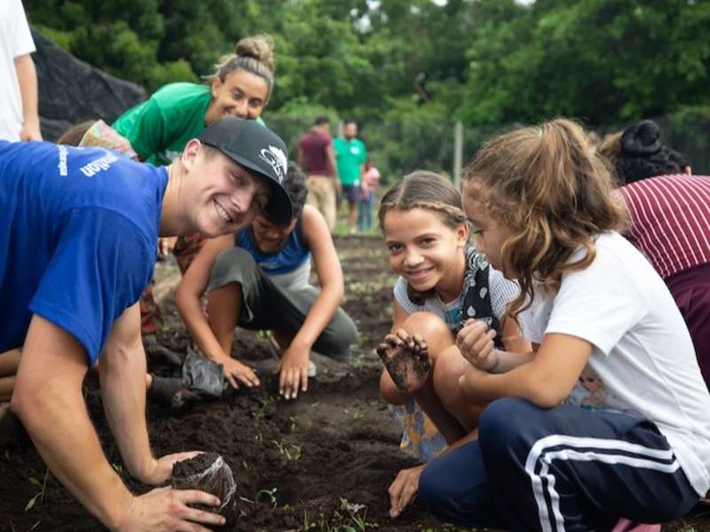Volunteers working on sustainable garden with local children.