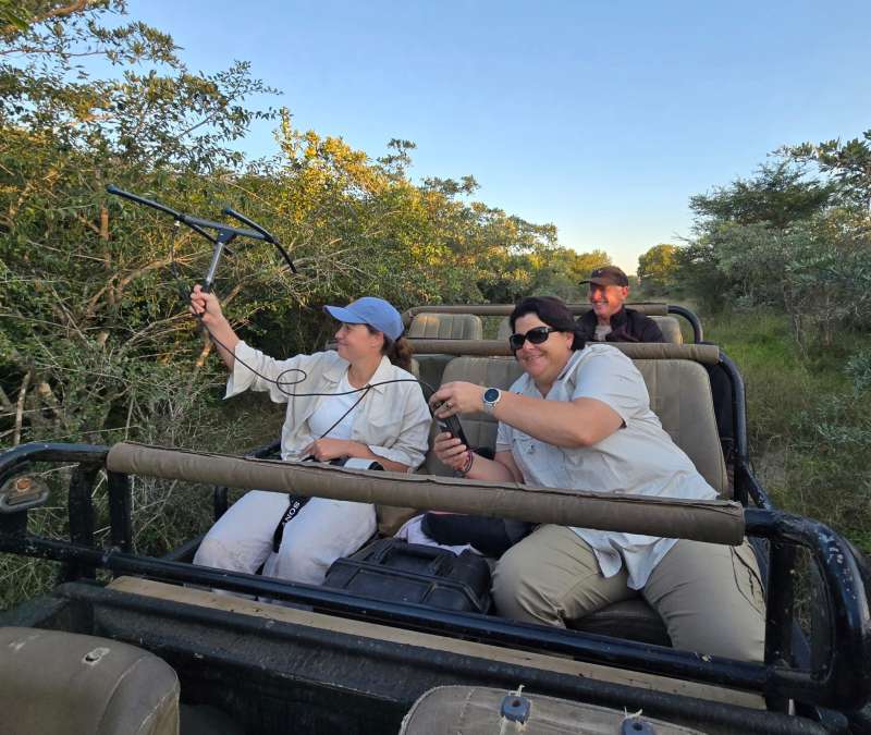 Volunteers working together in a vehicle, using telemetry to collect data for conservation