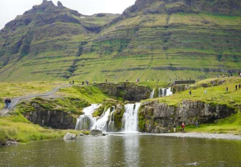 waterfalls and dramatic green mountains in Iceland