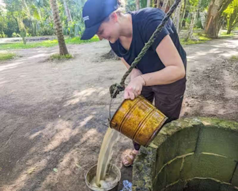 Woman Pouring Water for Deer to Drink