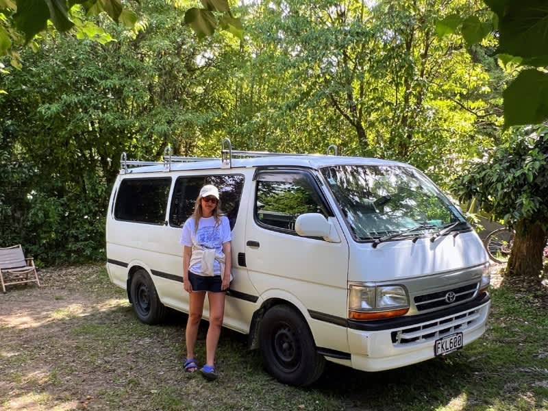 Woman standing in front of a campervan