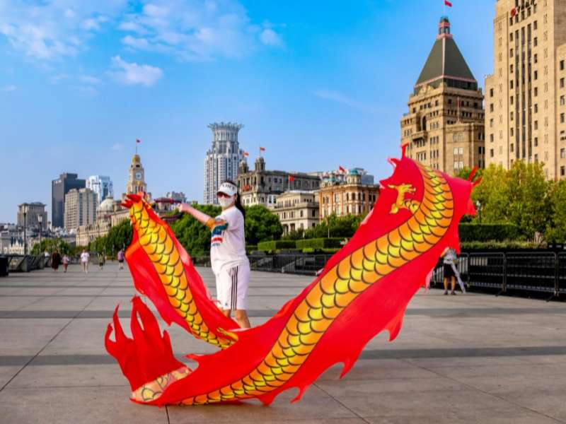 Woman waves dragon ribbon in shanghai