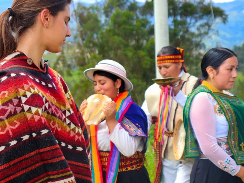 women-traditional-dress-bread-offering-ecuador